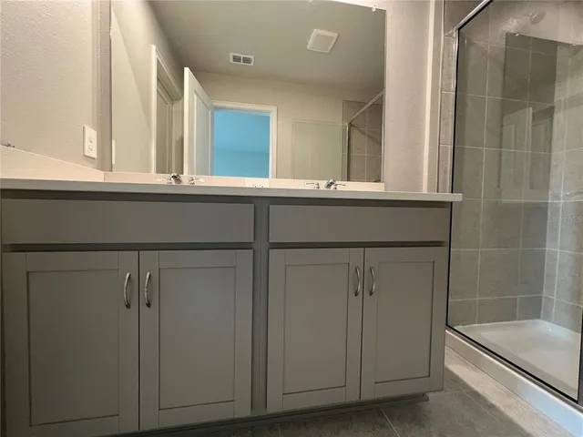 a view of a porch with a floor to ceiling window and wooden floor