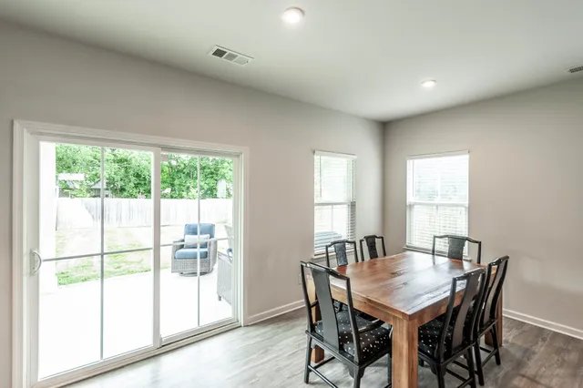 a living room with furniture a wooden floor and a window