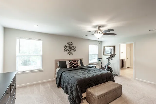 a bedroom with a large bed and a tv