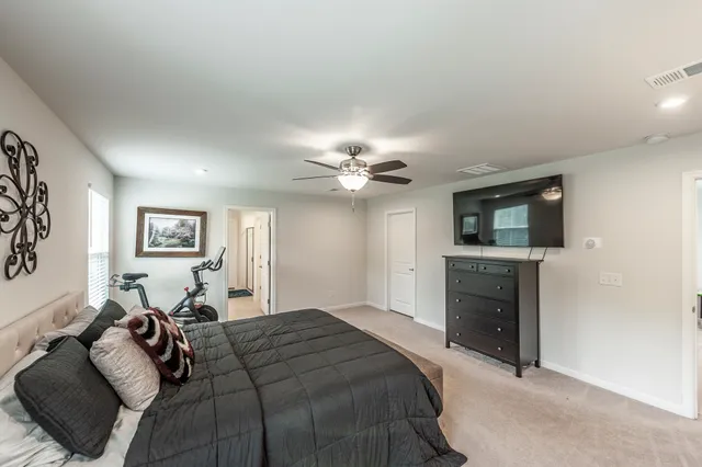 a bedroom with a bed and a flat screen tv