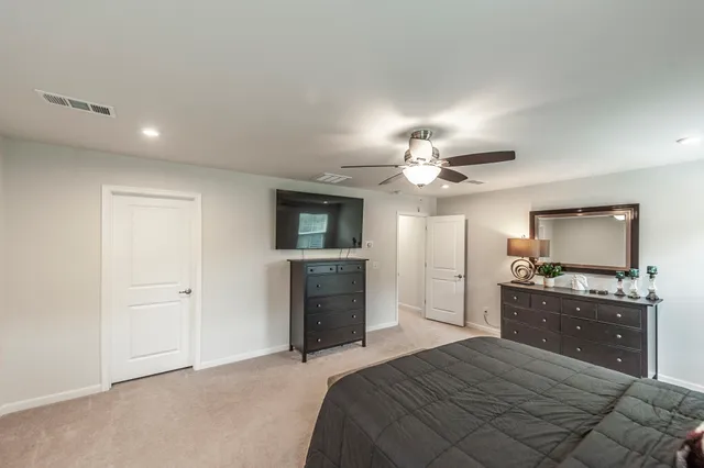 a spacious bathroom with a double vanity sink a large mirror and a bathtub