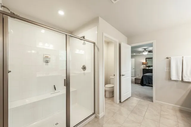 a view of a hallway with a livingroom and stairs