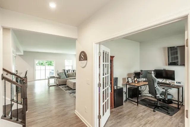 a view of a workspace with furniture and a window