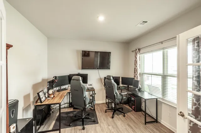 a living room with furniture wooden floor and window