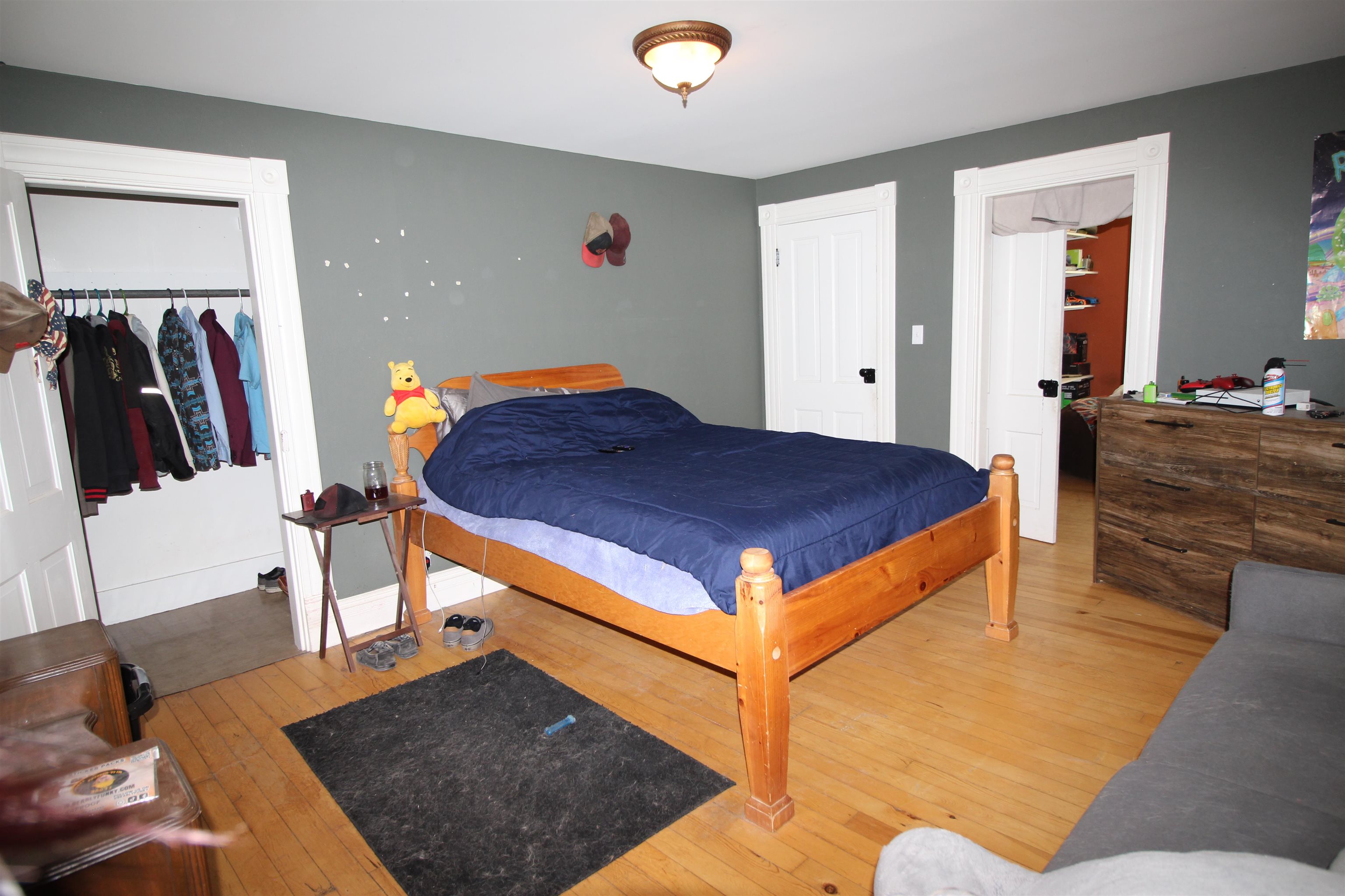 1150 East 7th Street Delta, CO 81416 - Photo 19 of 32 a bedroom with a bed and wooden floor