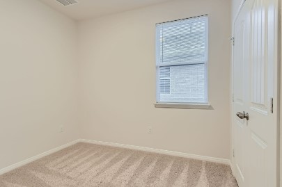709 Iron Brg Road Georgetown, TX 78626 - Photo 5 of 11 A well-proportioned bedroom with neutral carpet flooring and a single window offering natural light.