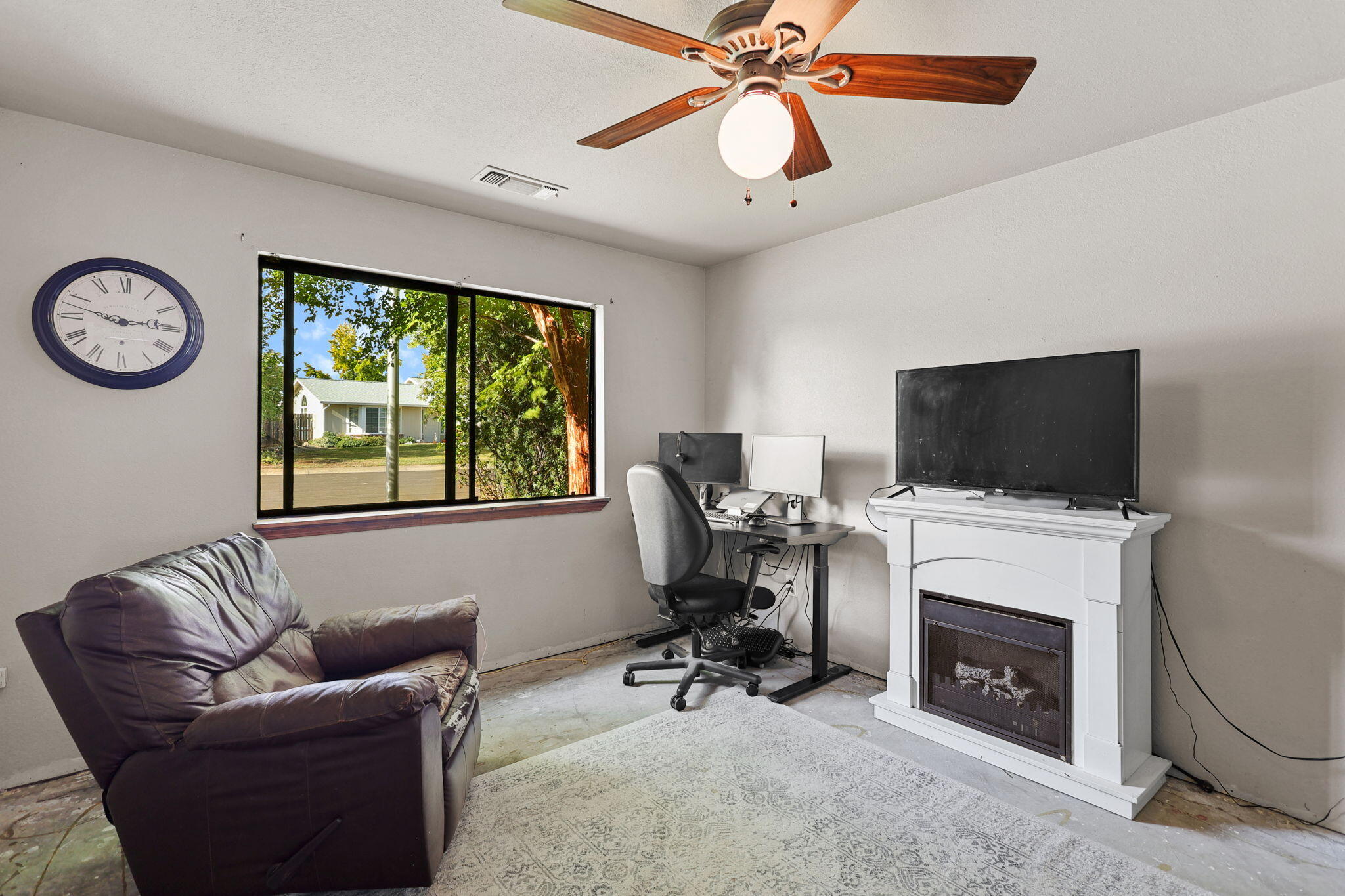 404 Woodhill Drive Redding, CA 96003 - Photo 16 of 52 a living room with furniture a flat screen tv and a fireplace