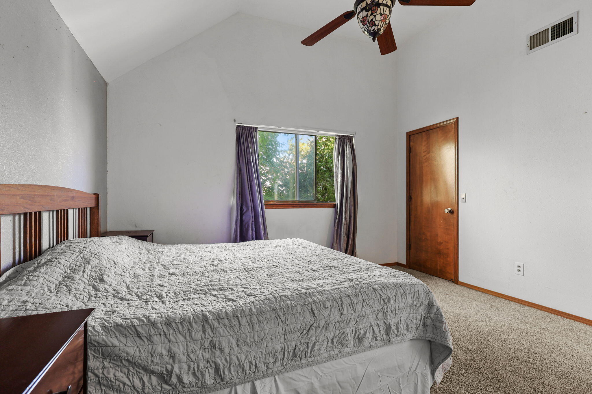 404 Woodhill Drive Redding, CA 96003 - Photo 21 of 52 a bedroom with a bed and a window