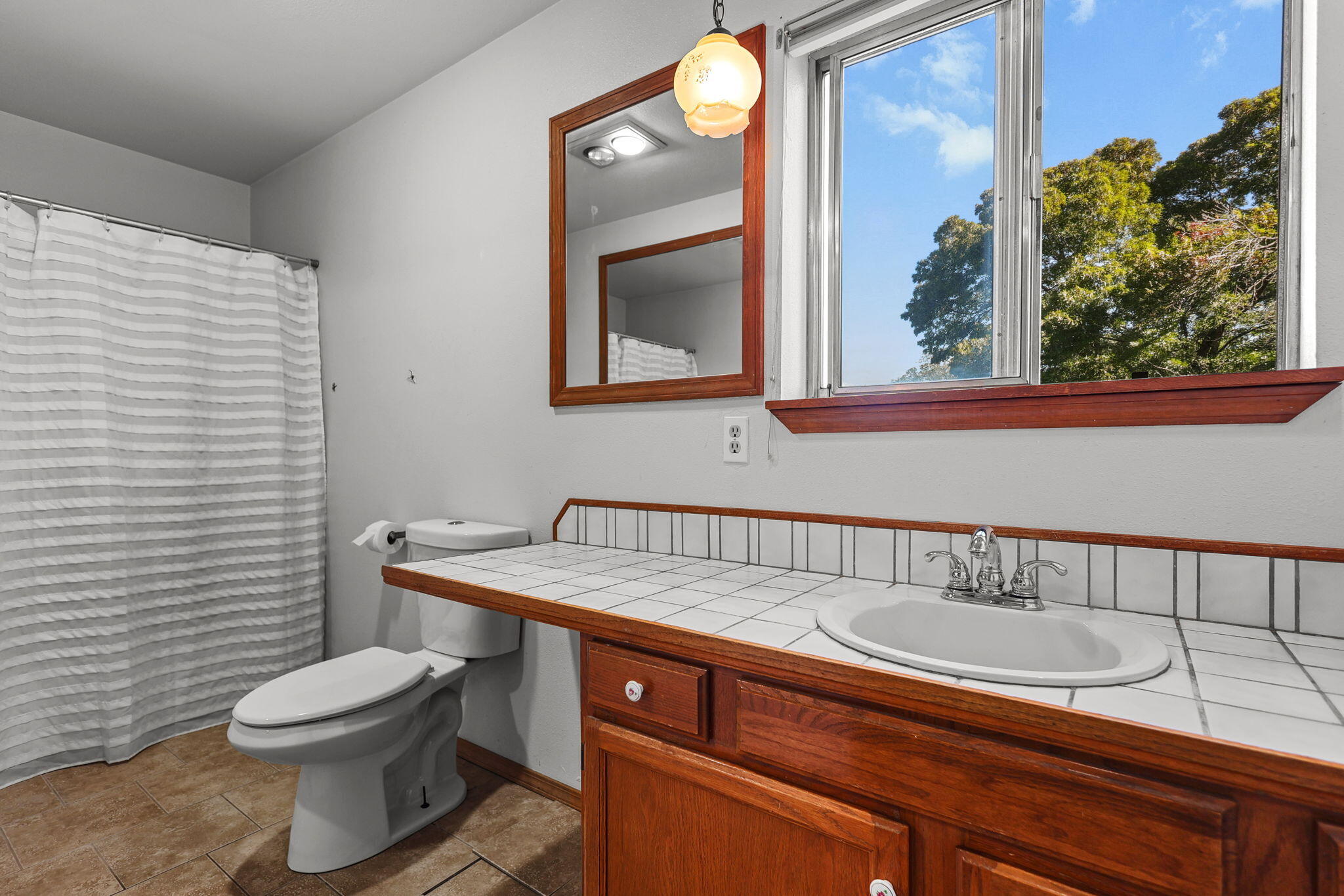 404 Woodhill Drive Redding, CA 96003 - Photo 24 of 52 a bathroom with a toilet a sink and mirror