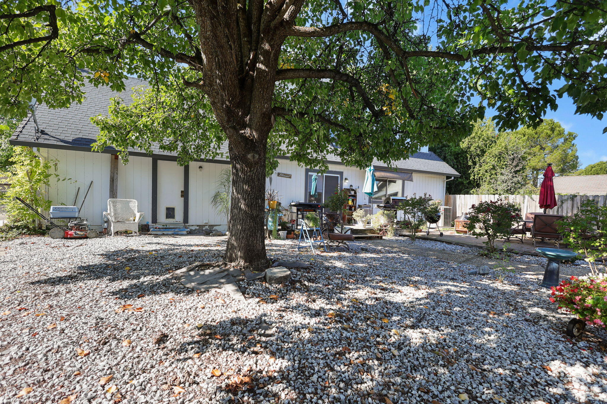 404 Woodhill Drive Redding, CA 96003 - Photo 30 of 52 a view of a house with a yard tree and a tree