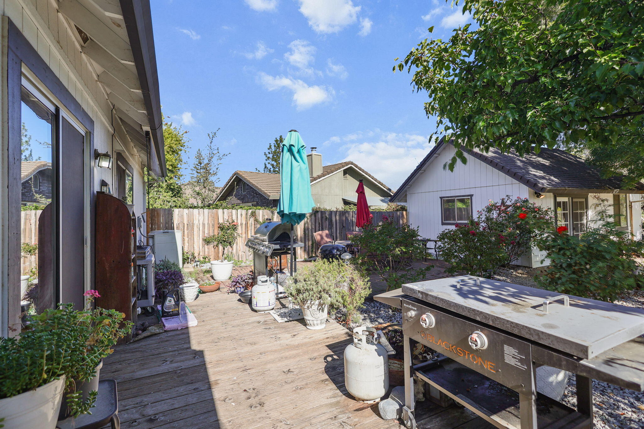 404 Woodhill Drive Redding, CA 96003 - Photo 34 of 52 a view of a patio with table and chairs and potted plants