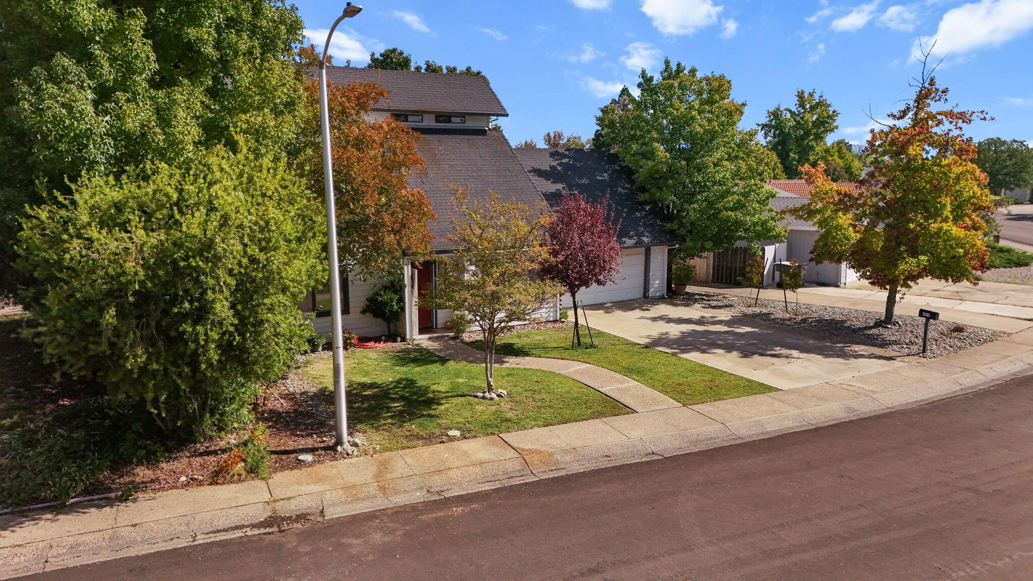 404 Woodhill Drive Redding, CA 96003 - Photo 48 of 52 a view of a house with backyard and tree