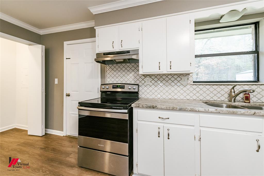198 7 Pines Road Benton, LA 71006 - Photo 13 of 30 a kitchen with granite countertop a sink cabinets stainless steel appliances and a window