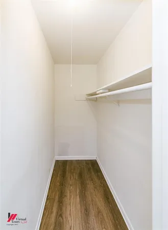 a view of a room with wooden floor and white walls