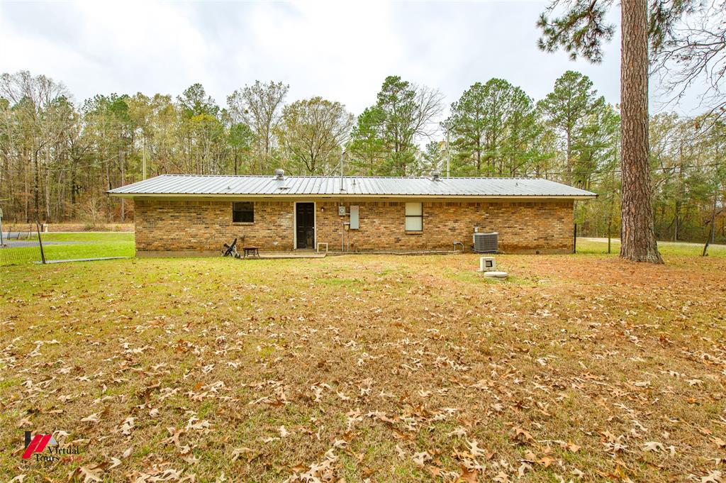 198 7 Pines Road Benton, LA 71006 - Photo 28 of 30 a view of swimming pool with lawn chairs and large trees