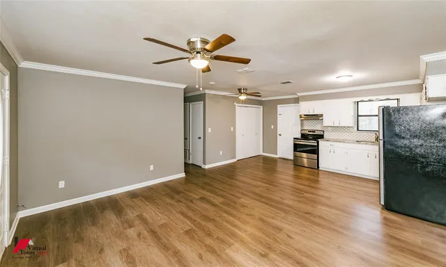 a view of a kitchen with a sink and a refrigerator