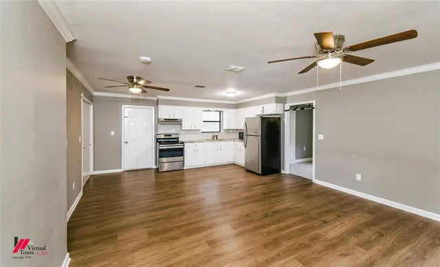 a view of a kitchen with a sink and cabinet with wooden floor