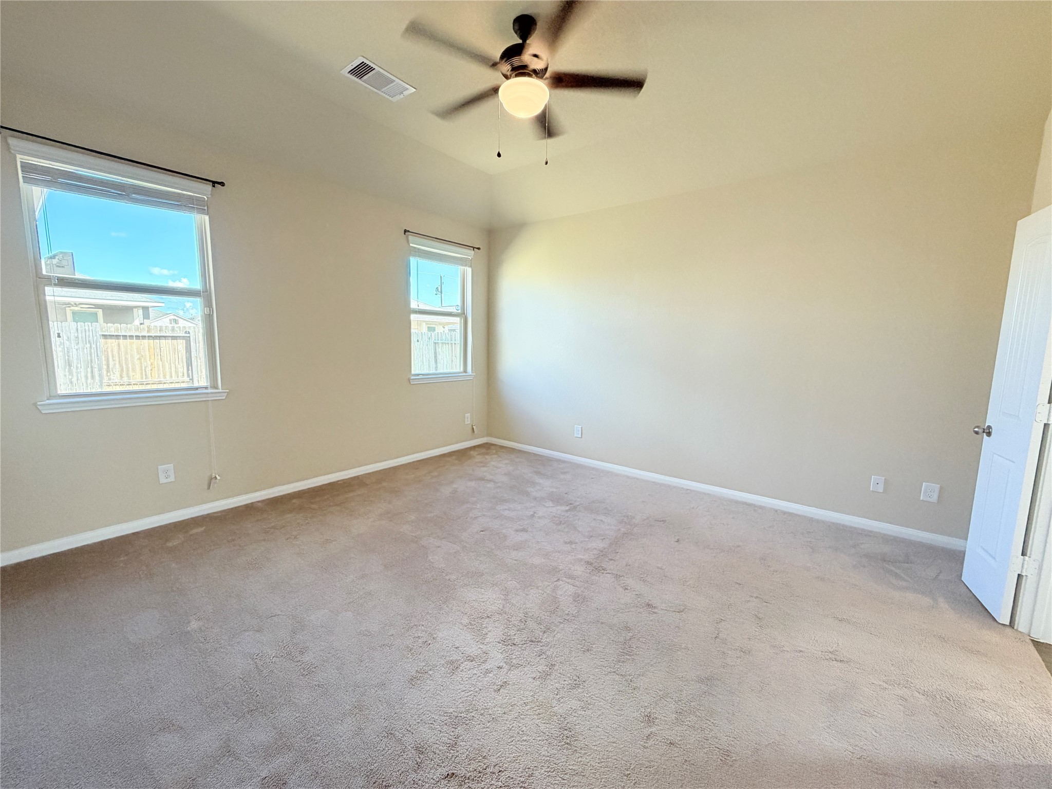 15613 All Star Drive Splendora, TX 77372 - Photo 11 of 25 an empty room with a window and a fan