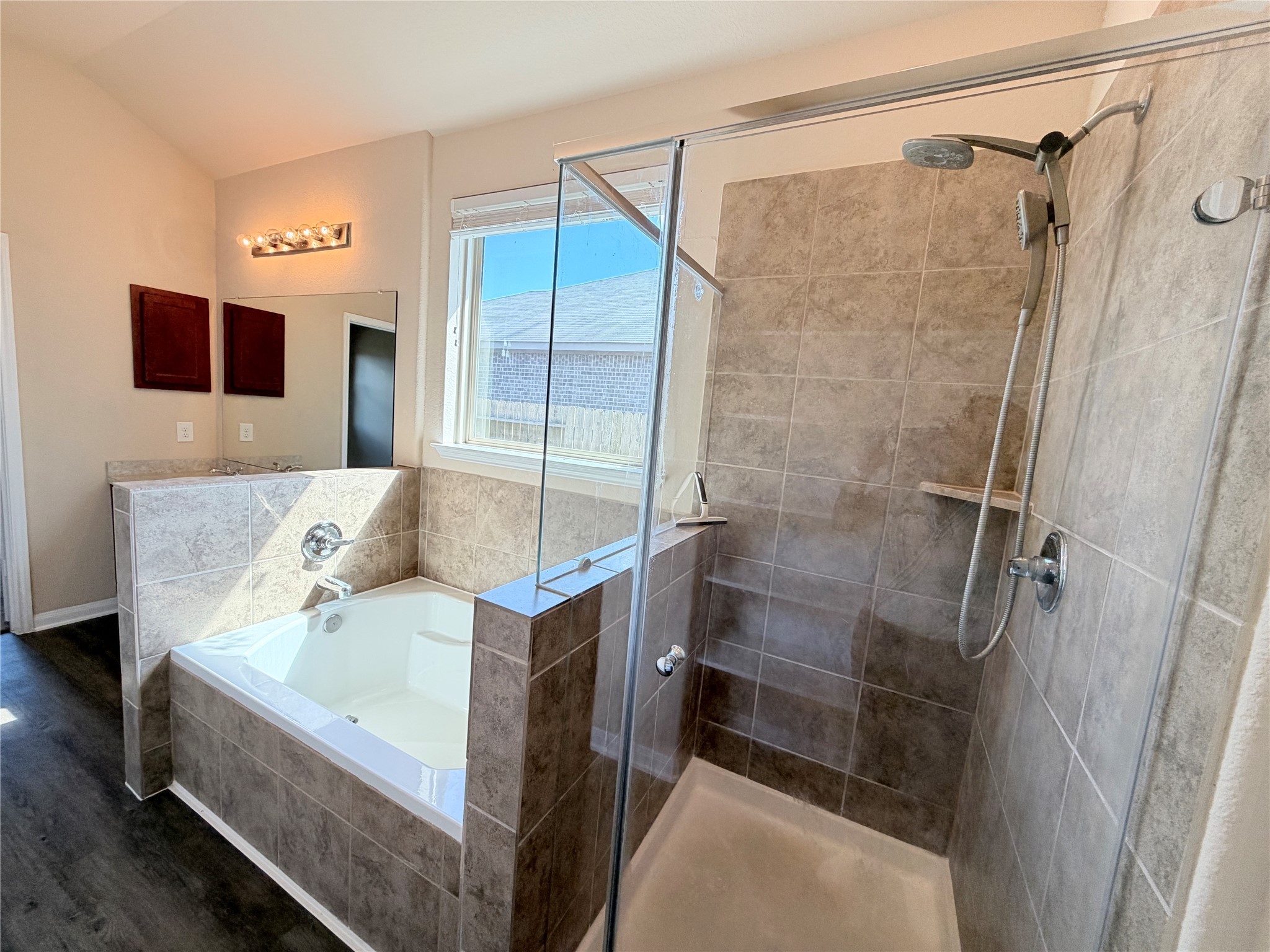 15613 All Star Drive Splendora, TX 77372 - Photo 14 of 25 a bathroom with a bathtub and a shower