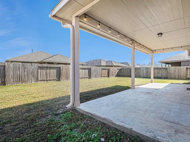 a view of an house with backyard and porch