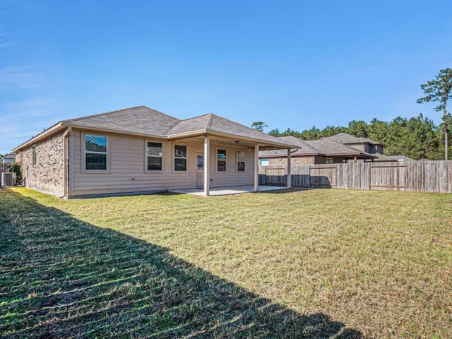 a view of a house with a backyard