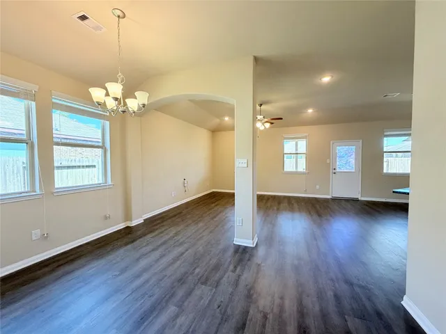 a view of a room with wooden floors and window