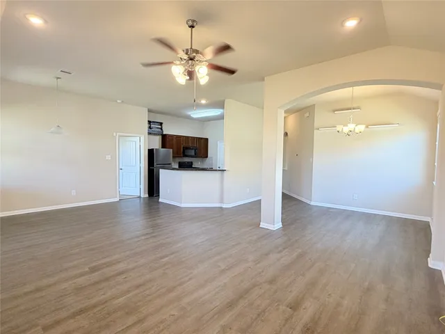 a view of a kitchen with a sink cabinets and wooden floor