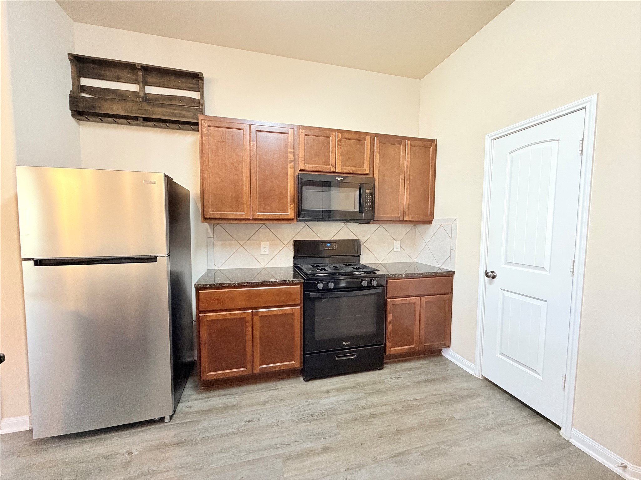 15613 All Star Drive Splendora, TX 77372 - Photo 9 of 25 a kitchen with stainless steel appliances granite countertop a refrigerator sink and stove
