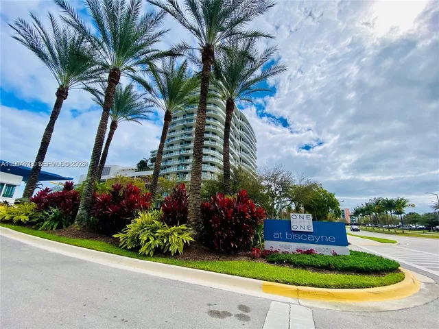 a view of a house with a yard and potted plants