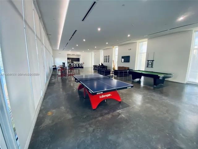 a kitchen with stainless steel appliances kitchen island granite countertop a refrigerator and stove