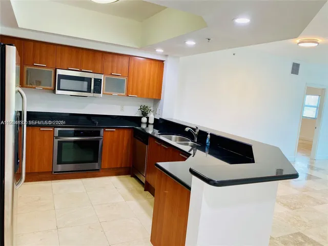 a kitchen with stainless steel appliances a stove and a refrigerator