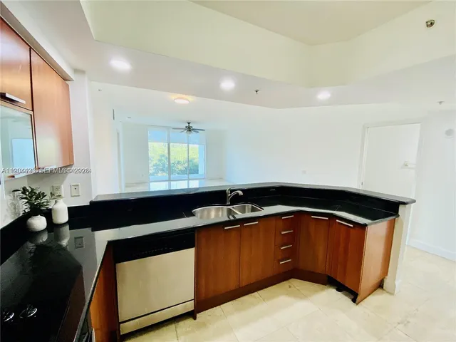 a kitchen with a sink and a stove top oven