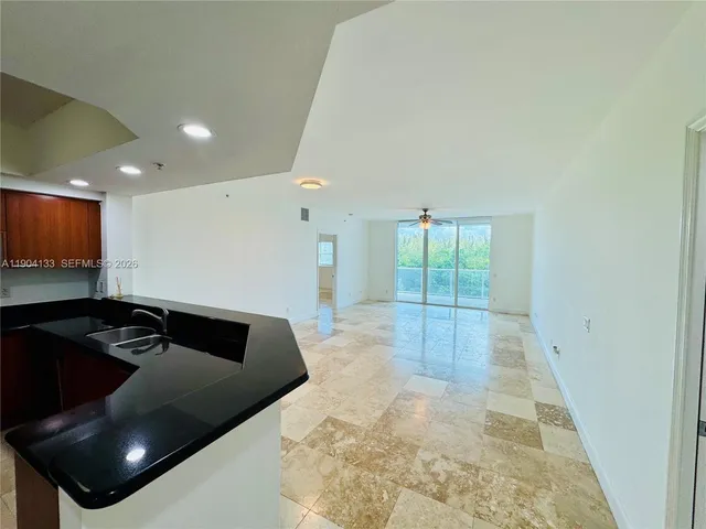 a kitchen with a sink and a refrigerator