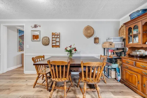 a view of a dining room with furniture and chandelier