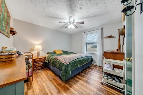 a bedroom with a bed and a chandelier