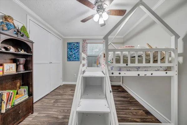 a view of a living room with furniture and wooden floor