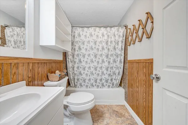 a bathroom with a toilet a sink and a shower