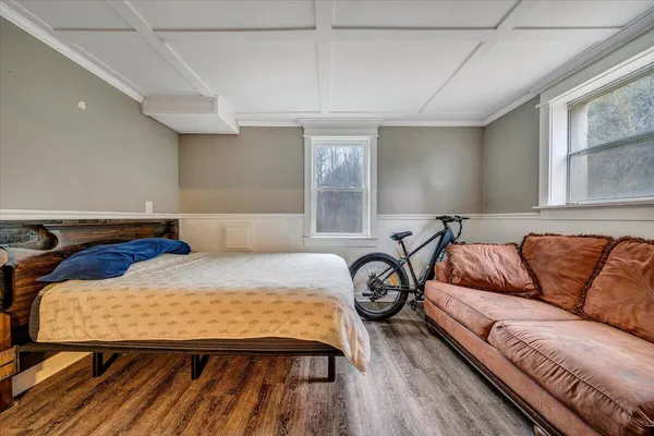 a living room with a couch and a wooden floor