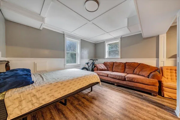 a bedroom with furniture and wooden floor