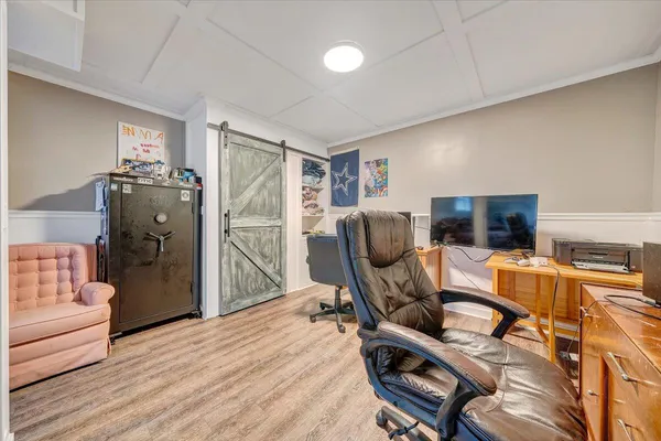 a view of a workspace with furniture and a window