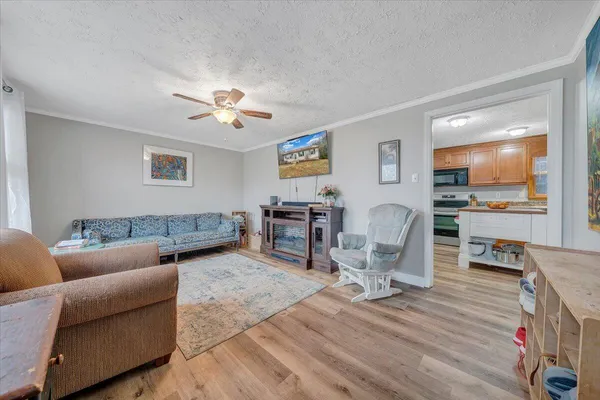 a living room with furniture and wooden floor