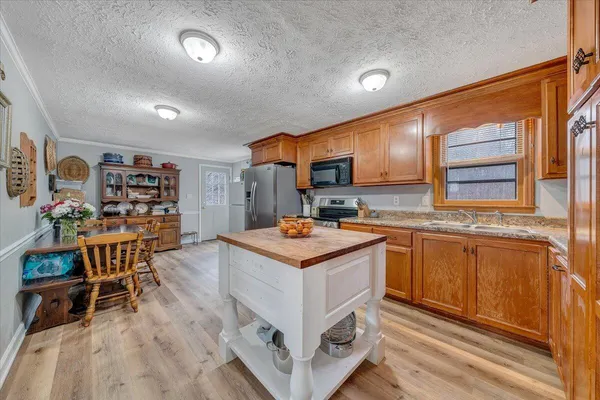 a kitchen with stainless steel appliances granite countertop a stove and a refrigerator