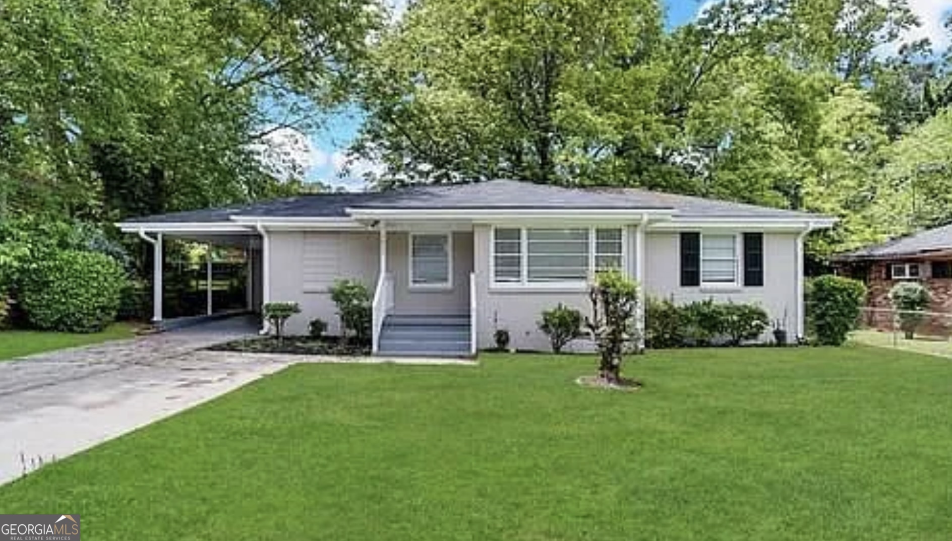 a backyard of a house with yard and barbeque oven