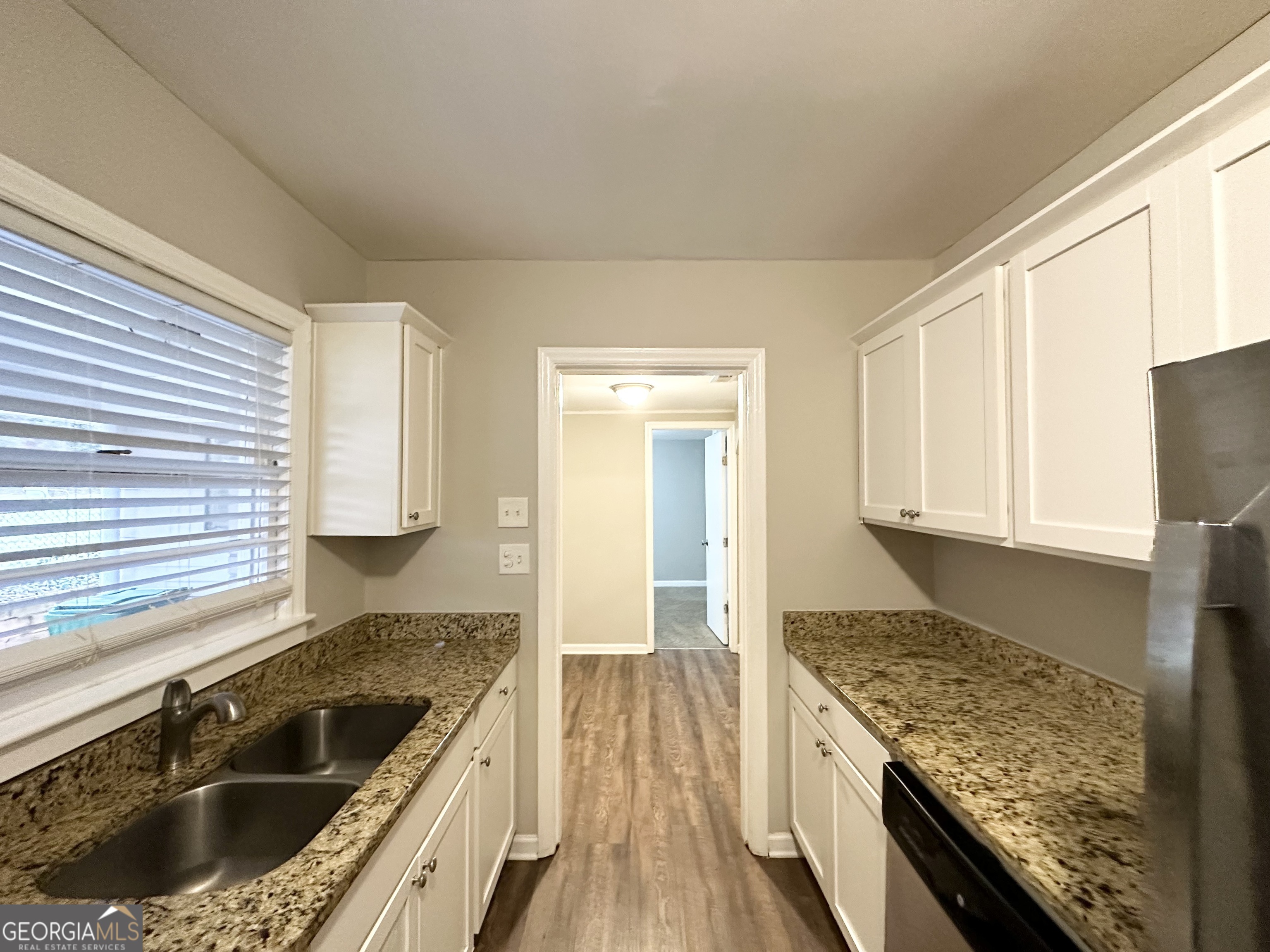 3011 Belvedere Lane Decatur, GA 30032 - Photo 7 of 13 a kitchen with granite countertop a sink stove and cabinets