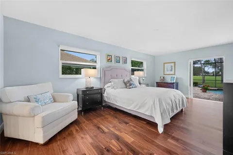 a spacious bedroom with a bed and a large window