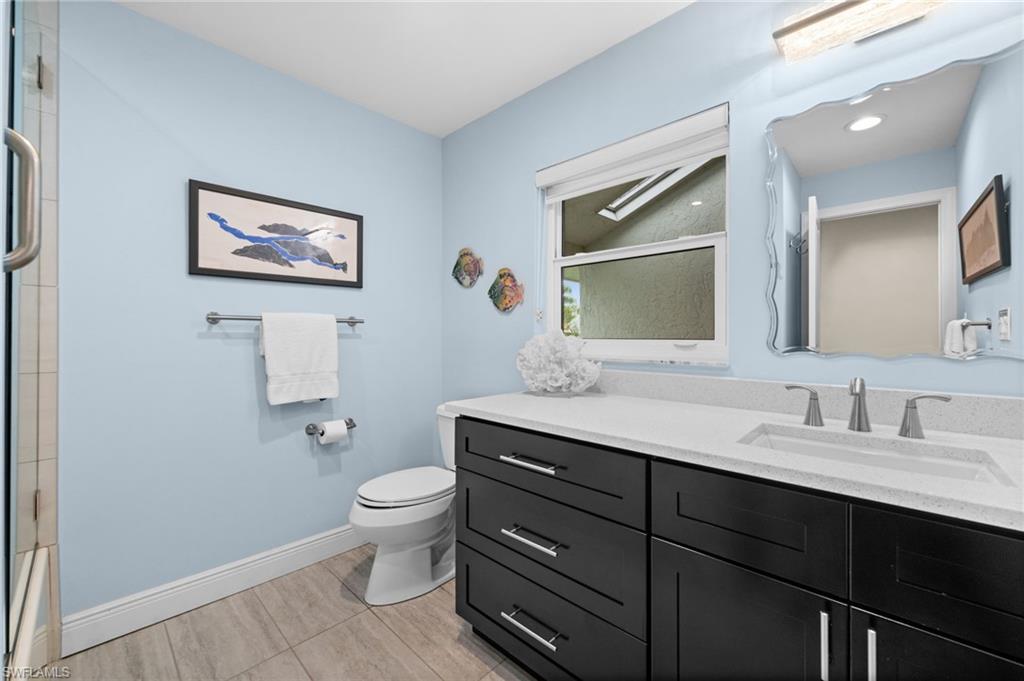 1960 Imperial Golf Course Boulevard Naples, FL 34110 - Photo 20 of 38 Renovated guest bath with sleek vanity and updated lighting