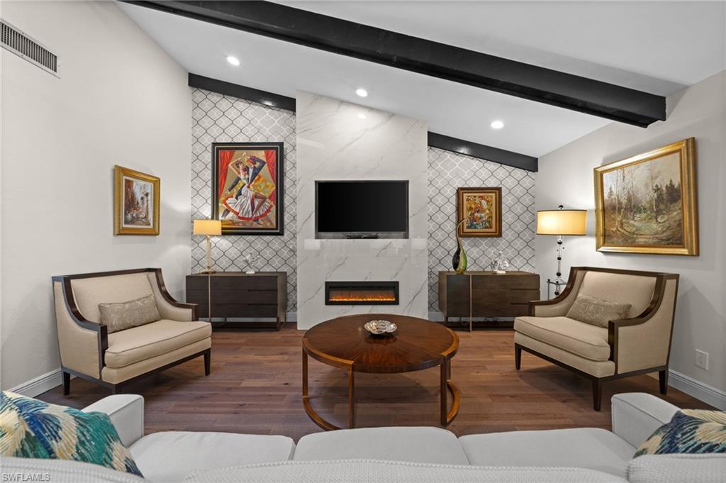 1960 Imperial Golf Course Boulevard Naples, FL 34110 - Photo 3 of 38 Stylish living space with marble-look fireplace surround and curated designer finishes