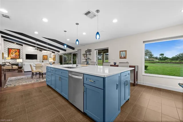a kitchen with sink stove and cabinets