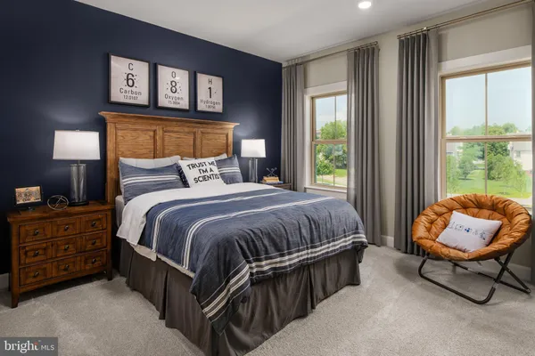 a bedroom with a bed chair and window