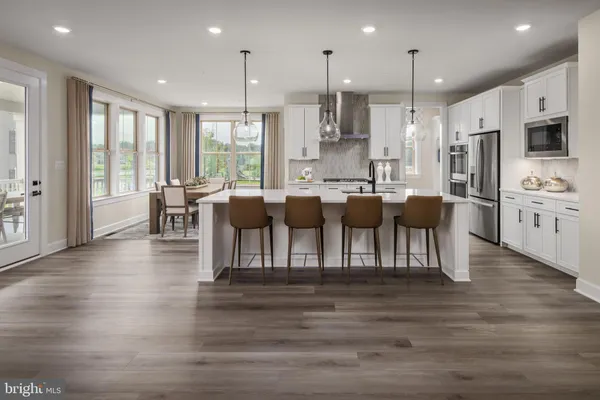 a large kitchen with lots of counter space and stainless steel appliances